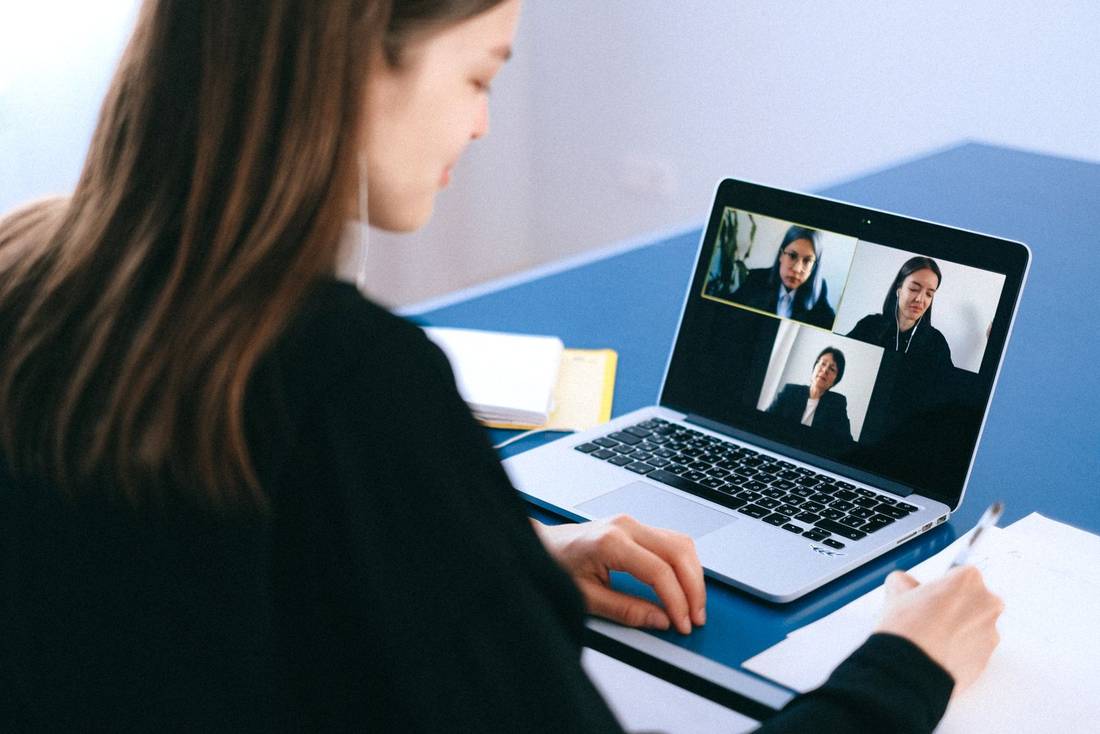 A remote call, with notes beside the laptop
